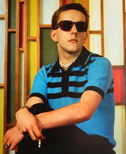 Photo of singer Terry Hall. He is wearing sunglasses.