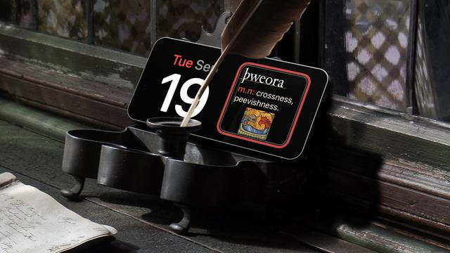 An iPhone in StandBy mode showing the Old English word of the day widget on the left. þweora, crossness, peevishness. Today's date is on the left. The iphone sits at the back of a metal ink well with a feather in it on an old wooden desk.