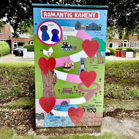 Utilities street box painted with a board game “Romantic Raheny”: The artist says “Having spent most of my initial dates with my husband here, we have discovered Raheny is full of romantic hotspots. This fun piece highlights some of Raheny’s hidden gems through a board game where one can roll the dice and see where they might go for their next date. We hope others find love here, and fall head-over-heels for the Raheny area too.”