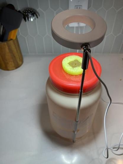 The halo ring grow light is attached to the bin using duct tape.