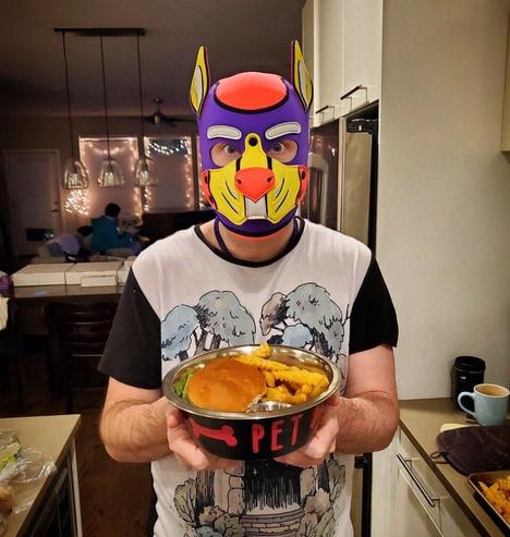 A human pup holding a bowl of food that says "pet"
