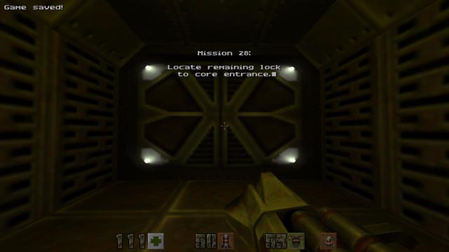 The player is aiming a rocket launcher at what looks like a hangar bay door. Text is displayed on the screen:

"Mission 28: Locate remaining lock to core entrance."