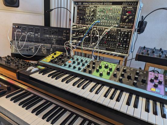 Moog Matriarch and Korg ARP 2600 next to a rack of modular music gear.
