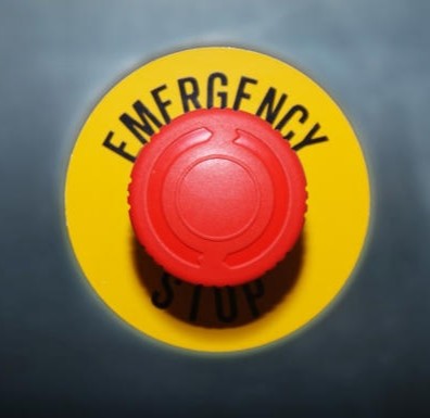 A bright red circulat button with the label emergency