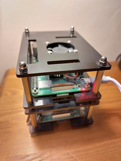 A stack of 2 Raspberry Pi computers sitting on a desk. They're tiny. It's adorable.