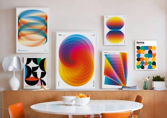 A photo of a living room with several colorful posters on the wall.
