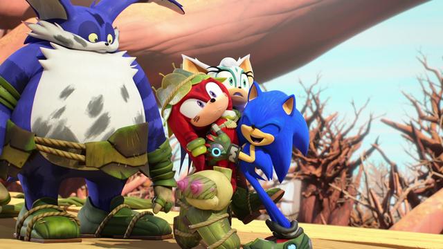IMG 2 - En review
Sonic abrazando a Knucles y Rouge versión tribal, en un bosque lleno de árboles sin hojas. Sale Big Cat a la izquierda mirándolos.