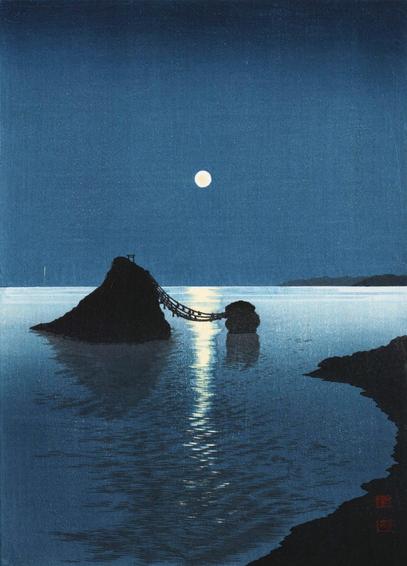 An evening view looking out toward Meoto Iwa, two sacred rocks standing in the sea off the shore of Ise, in Mie Prefecture. The rock on the left is taller with a wider base, while the rock on the right is smaller; a sliver of the shore is visible on our right. Separated by the water, the two rocks are joined by a shimenawa, a straw rope common to Shinto shrines. A small torii gate stands on top of the larger rock. Above, a bright full moon shines in a starless night sky, silvering the calm sea and reducing the two rocks to silhouettes.