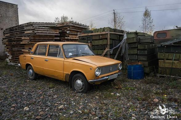 orange car near ammo boxes