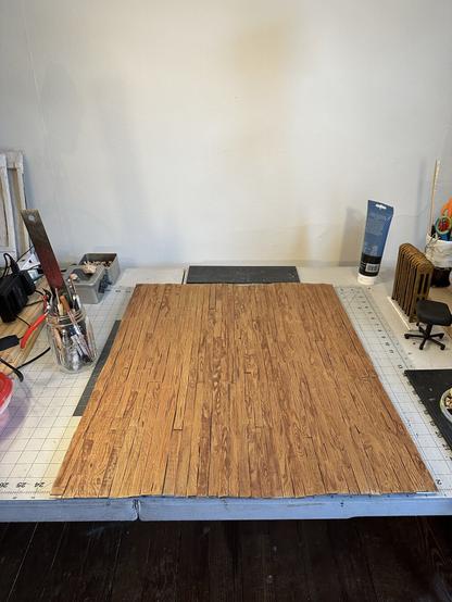a miniature wood floor made of cardboard, mod podge, acrylic, and watercolor pencil