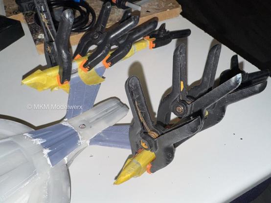 Both warp nacelles are wrapped with yellow masking tape and black clamps.