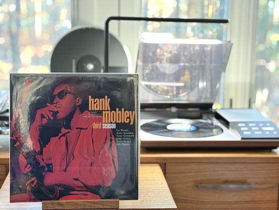 Hank Mobley - Third Season LP cover.

A red-tinted shot of Mobley, smoking a cigarette, holding his sax, facing left.

The black LP plays on a vintage, restored Bang & Olufsen Beogram 8002 linear-tracking turntable to the right.