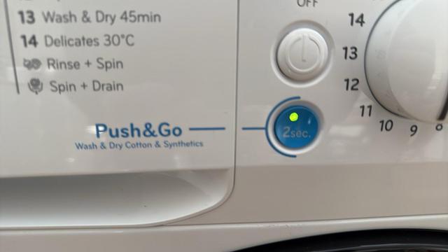 Close up photo of a washing machine control panel showing a button labelled Push & Go.