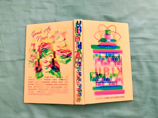 A book titled Ubik is shown against a blue-green background. The book is open in such a way that the entire hard cover is on display. The book is wrapped in canvas that is printed with a colorful design. The design background is a peach yellow. The front cover shows a flat painted image of a spray can labeled “Ubik” depicted in vibrant colors of green, pink, red, and blue, but the image is purposefully distorted, as if misprinted and smeared. The spine title and back cover illustration are similarly distorted. The back cover shows what looks like a vintage advertisement for Ubik, but the text is blurred to the point of unreadability. The only readable text is at the top, which is written in red cursive: GOOD AS NEW.