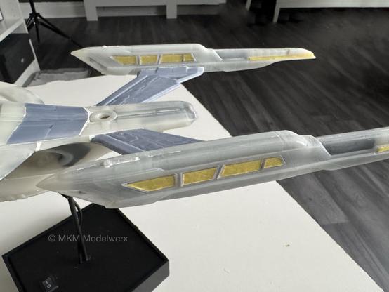 Warp nacelles with yellow masking tape covering clear parts