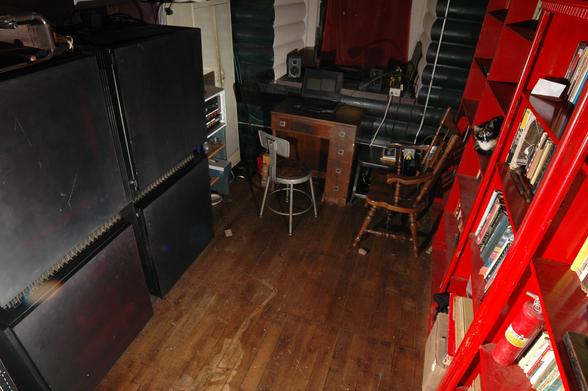 A Connection Machine supercomputer in a very small room with bookshelves, a desk, and a cat.