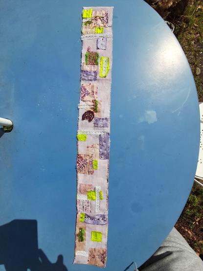 The scrollbook in full length. Description in post 1. It's a colourful collage of scraps and wild embroidery on a bright purple flannel. It can be hanged on a wall or rolled on a vintage wooden bobbin.