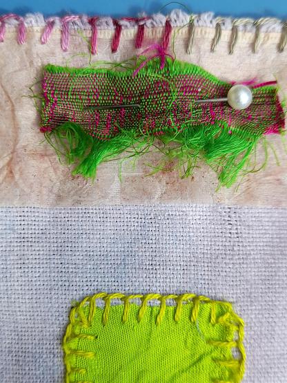 Detail: Some scraps are tiny but fascinating in their colours like a yellowish green silk square and a rectangle of green-pink woven silk on tea bag paper.