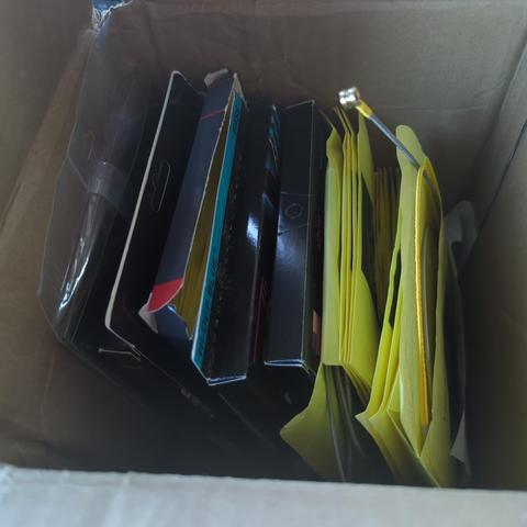 top down view of several boxes of bass guitar strings in a box