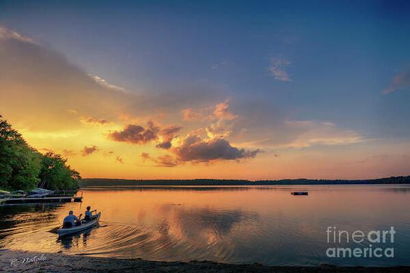 Color photograph of a father and son canoeing at sunset on Twin Lakes PA
