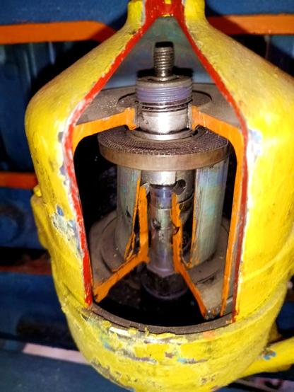 The famous centrifugal oil filter, a sector cut away all the way to the center, painted in orange, red and yellow contrast colours.