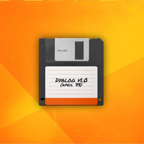A black 3.5-inch floppy disk with a silver metal shutter and a white label. The label has handwritten text reading “Dyalog v1.0 (April '83)” in black ink. The background is a gradient of orange and yellow tones with soft lighting and geometric shapes, giving the image a retro-tech aesthetic.