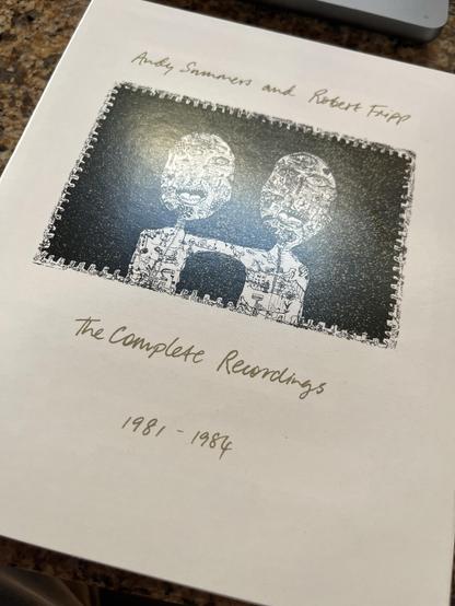 Image of a CD cover featuring "Andy Summers and Robert Fripp" titled "The Complete Recordings 1981-1984." The design includes an artistic black and white illustration of two figures with detailed patterns, bordered with a decorative edge