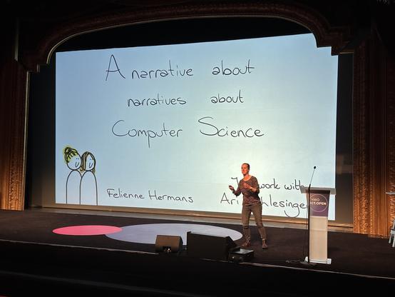 Felienne presents her title slide: A narrative about narratives about Computer Science. She drew cute cartoons of her and her collaborator.