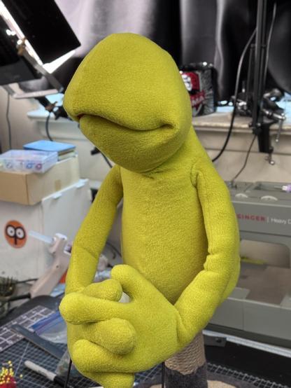 A green goblin hand puppet under construction