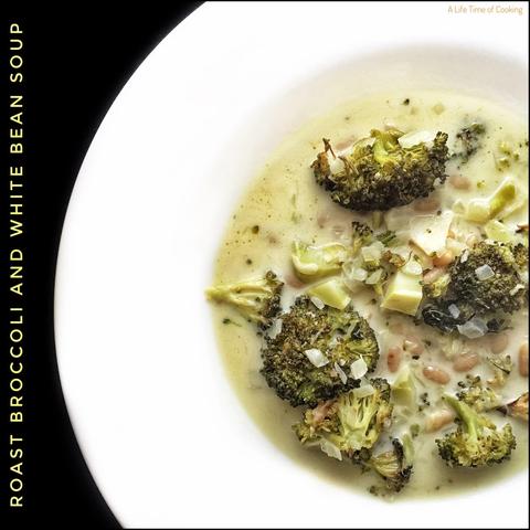 Roast broccoli and white bean soup sits in a white plate. The broccoli is chunky and sits in the creamy white bean base.
