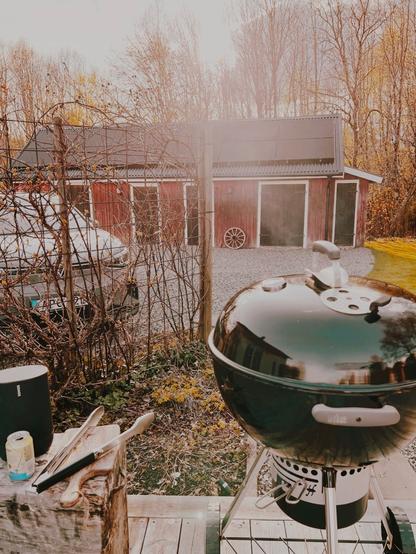 En klotgrill som ryker i kvällssolen.