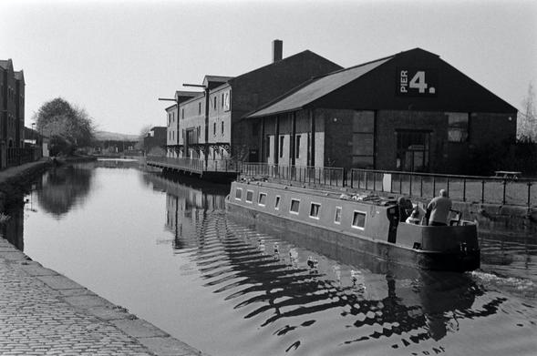 Narrowboat navigating the Leeds-Liverpool Canal through Wigan Pier