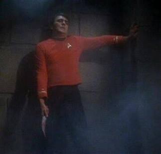 Scotty gripping a wall and holding a bloody knife