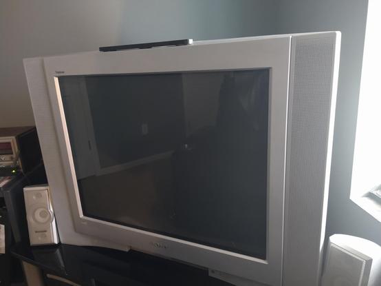 My newly acquired Sony KV-27FS210 sitting on top of a TV stand in the corner of a room