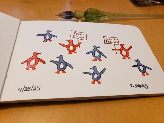Hand drawn generative/procedural art in ink on an open page of my sketchbook. The abstract drawing looks a bi like a bunch of penguins. Two of the penguins are holding up signs that read "f*ck cancer" and "f*ck fascists"