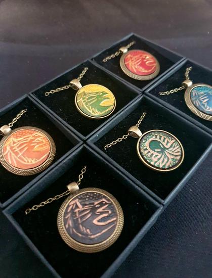 Necklace made of a brass chain and pendant with a French vegetable tanned leather insert, hand-tooled and hand-dyed.