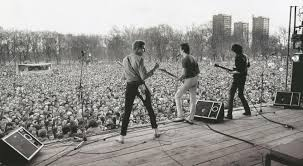 Back shot of the Clash on stage in front of the crowd at Victoria Park.