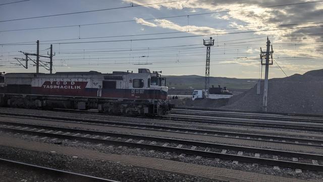 A huge TCDD diesel locomotive in sunset in a cargo railyard somewhere in Anatolia.