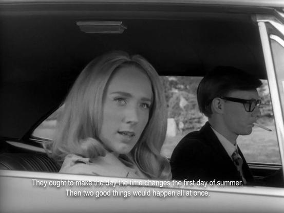 A blonde woman looking out of a car window. She's saying, “They ought to make the day the time changes the first day of summer. Then two good things would happen all at once. “