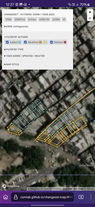 Screenshot of Changeset Map, visualizing the changes made against a satellite imagery background. I've added 17 buildings (shown as blue polygons) near the edge of Mandawali, close to Mohammadi Chowk.