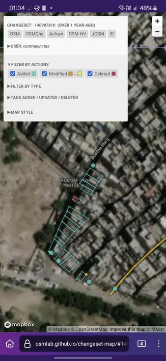 Screenshot of Changeset Map, visualizing the changes made against a satellite imagery background. I've added around 15 buildings (represented by blue polygons) along Buddha Marg, along with 4 POIs and a gate.