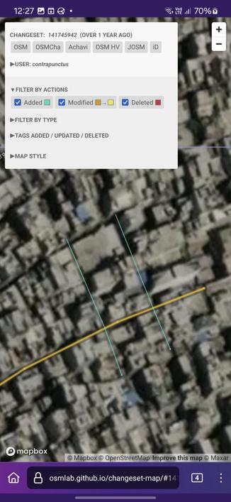 Screenshot of Changeset Map, visualizing the changes made against a satellite imagery background. I've added 2 streets (shown as blue lines) which cut across the main named street.