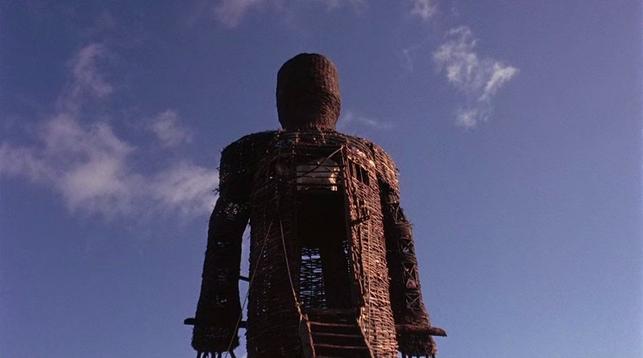 An image of a giant man-shaped figure assembled from twigs, the wicker man