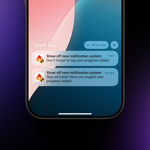 iPhone screen displaying two notifications from the Spark habit tracker app against a colorful gradient background. Both notifications titled “Show off new notification system” feature reminders: the top one (marked “now”) says “Don’t forget to log your progress today!” while the bottom one (from “1m ago”) reads “Stay on track! Have you logged your progress today?” Each notification includes the Spark logo. The notification group has “Show less” and close buttons at the top. The phone displays a smooth background gradient transitioning from pink to teal blue.