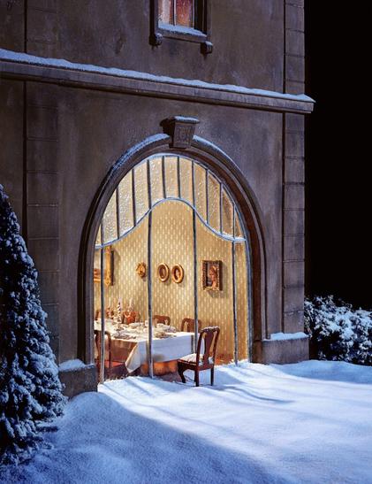 a photo of a miniature set showing an absurd scenario of a glass-fronted restaurant with snow outside, and a single chair and table are stuck outside, connected to the glass