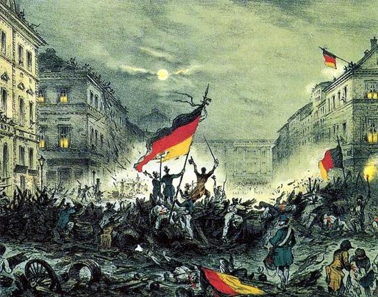Origin of the Flag of Germany: Cheering revolutionaries in Berlin, on 19 March 1848. By Unknown author – im Original: &quot;Erinnerung an den Befreiungskampf in der verhängnisvollen Nacht 18.-19. März 1848&quot;, Kreidelithographie, koloriert, gedruckt im Verlag Winckelmann, Eigenth. V. C. Glück, Berlin, Signatur rechts unten nicht lesbar, wohl Blatt II, post-1848 und zeitgenössisch (genaues Datum unbekannt), gescannt von User:APPER, siehe https://www.deutsche-digitale-bibliothek.de/item/YSA74GHCTOXUCF2V3JY6ZQ2CC3TKLHP2, Public Domain, https://commons.wikimedia.org/w/index.php?curid=364558