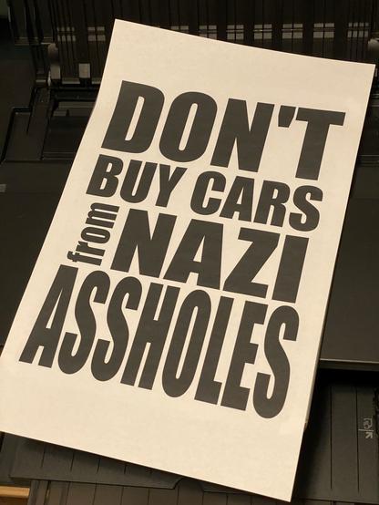 text artfully arranged saying “don’t buy cars from nazi assholes”