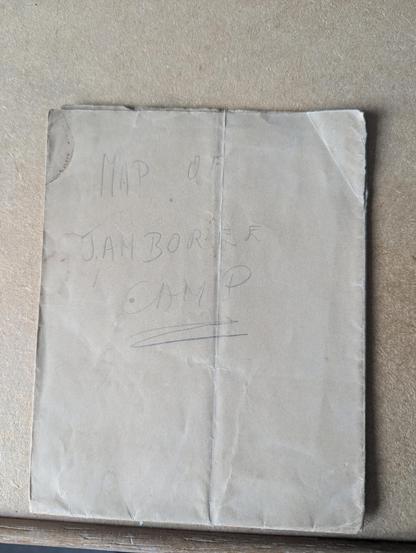 A piece of very old folded paper with faint writing in pencil which reads MAP OF JAMBOREE CAMP