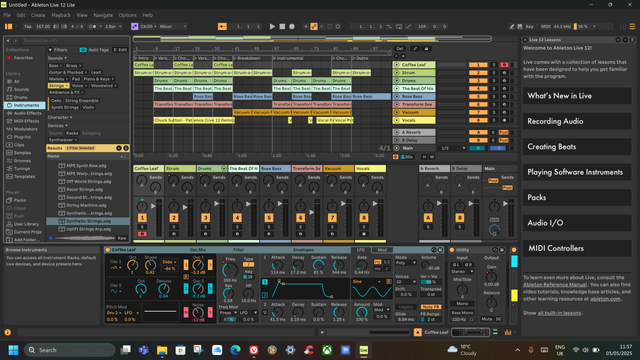 Screenshot of the Ableton Lite digital audio workstation. A rather complicated screen layout, mainly dark grey with numerous boxes and highlights in brighter colours. There are text selections on the left for various instruments and effects, a central grid laying out the individual parts of the music being worked on, dials and sliders below that, and further waveform indicators and adjusters along the bottom. There is not enough alt text in the world to adequately describe it, but it looks pretty baffling to me too.