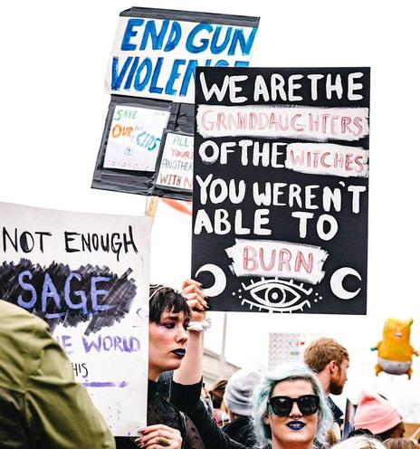 Protesters seek to "End Gun Violence," telling President Trump, "We are the Granddaughters of the Witches You Weren't Able to Burn," and "Not Enough Sage in the World"